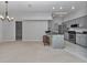 Modern kitchen with stainless steel appliances and a breakfast bar open to the living space at 8775 Sw 192 Ct, Dunnellon, FL 34432