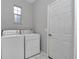 Bright laundry room featuring washer and dryer and exterior door at 8775 Sw 192 Ct, Dunnellon, FL 34432