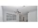 Bright living room with a ceiling fan and a large window offering plenty of natural light at 8775 Sw 192 Ct, Dunnellon, FL 34432