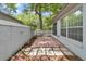 This outdoor patio features brick pavers, landscaping, and a privacy fence at 8775 Sw 192 Ct, Dunnellon, FL 34432