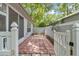 A lovely patio features red brick pavers, a small garden, and a white privacy fence at 8775 Sw 192 Ct, Dunnellon, FL 34432