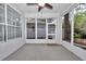 Screened porch featuring views of the backyard, neutral carpet and a ceiling fan at 8775 Sw 192 Ct, Dunnellon, FL 34432