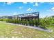 Scenic backyard featuring a screened-in patio and a lush privacy hedge at 8913 Sw 76Th Ln, Ocala, FL 34481