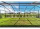 The screened-in lanai overlooks a well-manicured backyard with views of surrounding properties at 8913 Sw 76Th Ln, Ocala, FL 34481