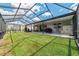 Wide angle view of a well kept backyard and covered patio/Lanai with plenty of space at 8913 Sw 76Th Ln, Ocala, FL 34481
