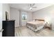 Cozy bedroom features a ceiling fan, black dresser, and neutral colored walls at 8913 Sw 76Th Ln, Ocala, FL 34481