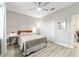 Well-lit bedroom with ceiling fan, closet, light-colored walls, and wood-look floors at 8913 Sw 76Th Ln, Ocala, FL 34481