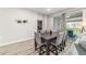 Dining room features modern table and chairs, sliding door with backyard view and decorative wall art at 8913 Sw 76Th Ln, Ocala, FL 34481