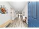 Inviting entryway with a blue front door, wood-look flooring, and stylish decor at 8913 Sw 76Th Ln, Ocala, FL 34481