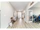 Bright entryway showcasing wood-look flooring, light walls, and access to other living spaces at 8913 Sw 76Th Ln, Ocala, FL 34481