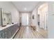 Light-filled entryway with wood-look floors, a white front door, and decorative accents at 8913 Sw 76Th Ln, Ocala, FL 34481