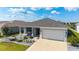Charming single-story home featuring a well-manicured lawn and a two-car garage at 8913 Sw 76Th Ln, Ocala, FL 34481