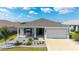 Charming single-story home featuring a well-manicured lawn and a two-car garage at 8913 Sw 76Th Ln, Ocala, FL 34481