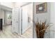 Bright hallway with neutral walls and wood-look floors leads to bathroom and bedroom at 8913 Sw 76Th Ln, Ocala, FL 34481