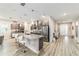 Open kitchen layout with a granite island, stainless steel appliances, and wood-look flooring at 8913 Sw 76Th Ln, Ocala, FL 34481