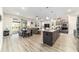 Open-concept kitchen with a large island, stainless steel appliances, and adjacent living areas at 8913 Sw 76Th Ln, Ocala, FL 34481