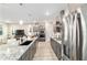 Modern kitchen features stainless steel appliances, gray cabinets, and granite countertops with pendant lighting at 8913 Sw 76Th Ln, Ocala, FL 34481
