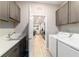 Laundry room features gray cabinets, sink, and appliances for added convenience at 8913 Sw 76Th Ln, Ocala, FL 34481