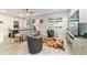Cozy living room featuring a sofa, chairs, a large window, and stylish decor elements at 8913 Sw 76Th Ln, Ocala, FL 34481