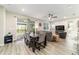 Open-concept living area with a dining table, comfortable seating, and sliding glass doors to the patio at 8913 Sw 76Th Ln, Ocala, FL 34481