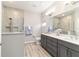 Modern main bathroom with double vanity, quartz counters, tiled shower with glass door at 8913 Sw 76Th Ln, Ocala, FL 34481