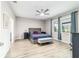 Spacious main bedroom with blue bedding, ceiling fan and two windows letting in lots of light at 8913 Sw 76Th Ln, Ocala, FL 34481