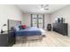 Relaxing main bedroom with light gray walls, blue bedding and lots of natural light at 8913 Sw 76Th Ln, Ocala, FL 34481