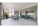 Covered patio area with comfortable seating, offering a relaxing outdoor living space overlooking the well-maintained backyard at 8913 Sw 76Th Ln, Ocala, FL 34481