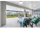 Inviting screened-in patio featuring comfortable seating and a view of the landscaped backyard at 8913 Sw 76Th Ln, Ocala, FL 34481