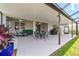 Large screened-in patio with dining and seating areas, ideal for enjoying outdoor living and backyard views at 8913 Sw 76Th Ln, Ocala, FL 34481