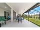 Spacious covered patio with outdoor seating, perfect for entertaining guests and enjoying the backyard view at 8913 Sw 76Th Ln, Ocala, FL 34481