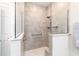 Tiled walk-in shower with grab bar and seat niche provides a spa-like experience at 8913 Sw 76Th Ln, Ocala, FL 34481