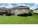 Exterior view of the backyard featuring the house and landscaping at 9047 Sw 102Nd Cir, Ocala, FL 34481