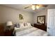 Comfortable bedroom featuring a ceiling fan, dresser with mirror, and decorative pillows at 9047 Sw 102Nd Cir, Ocala, FL 34481