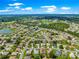 An elevated view showcases the community's proximity to golf course and lake, surrounded by trees at 9120 Se 125Th Loop, Summerfield, FL 34491