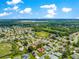 An elevated view of a residential community with a lakeside backdrop, highlighting neighborhood charm at 9120 Se 125Th Loop, Summerfield, FL 34491