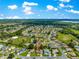 An elevated view of a residential community with a lakeside backdrop, highlighting neighborhood charm at 9120 Se 125Th Loop, Summerfield, FL 34491