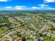 An aerial perspective showcasing a community near a pond, surrounded by a lush landscape, for tranquil living at 9120 Se 125Th Loop, Summerfield, FL 34491