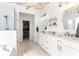 Stylish bathroom features double sinks, modern vanity, glass shower, and a walk-in closet at 9120 Se 125Th Loop, Summerfield, FL 34491