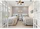 Bright bedroom with stylish patterned wallpaper and hardwood style floors at 9120 Se 125Th Loop, Summerfield, FL 34491