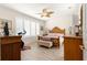 Tranquil bedroom features shuttered windows, a ceiling fan, and wood-look flooring at 9120 Se 125Th Loop, Summerfield, FL 34491