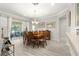 Bright dining area features recessed lighting, chandelier, and sliding glass doors to the lanai at 9120 Se 125Th Loop, Summerfield, FL 34491
