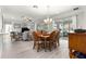 Open-concept dining area features recessed lighting, chandelier, and sliding glass doors to the lanai at 9120 Se 125Th Loop, Summerfield, FL 34491
