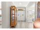 Bright entryway showcasing hardwood style floors and glass paneled doors leading to a bedroom at 9120 Se 125Th Loop, Summerfield, FL 34491
