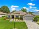 Charming single story home with beautiful landscaping, paver driveway and neutral color palette at 9120 Se 125Th Loop, Summerfield, FL 34491