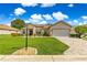 Charming home with a manicured front lawn, brick driveway, mature landscaping, and attached two-car garage at 9120 Se 125Th Loop, Summerfield, FL 34491