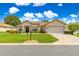Charming single-story home with a well-manicured lawn and inviting curb appeal under sunny blue skies at 9120 Se 125Th Loop, Summerfield, FL 34491
