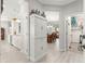 Hallway view of the kitchen, dining area, and a well-organized storage room at 9120 Se 125Th Loop, Summerfield, FL 34491
