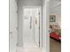 Hallway leading to a bright white bathroom and bedroom at 9120 Se 125Th Loop, Summerfield, FL 34491
