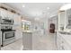 Well-lit kitchen features an island, pendant lighting, white cabinets, and modern appliances at 9120 Se 125Th Loop, Summerfield, FL 34491